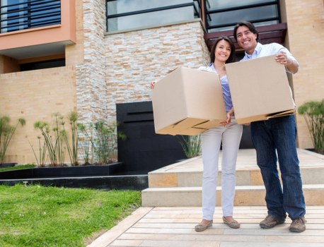 Movers carrying household items through a Kingscross apartment building